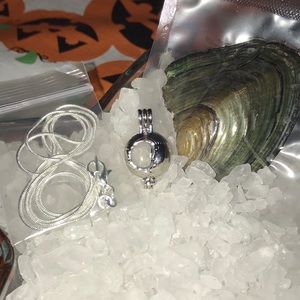 Crescent moon cage with chain and oyster